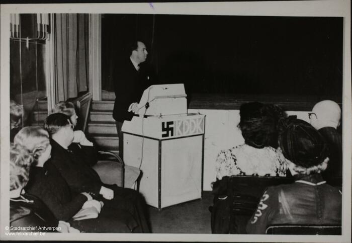 Joris Diels behind a rostrum with a swastika