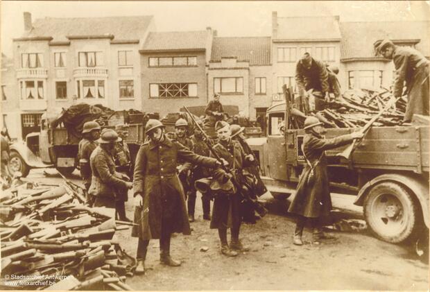 Soldiers capitulate and put down their weapons on a stack