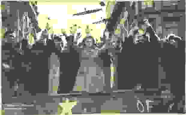 A group of people standing with their hands up